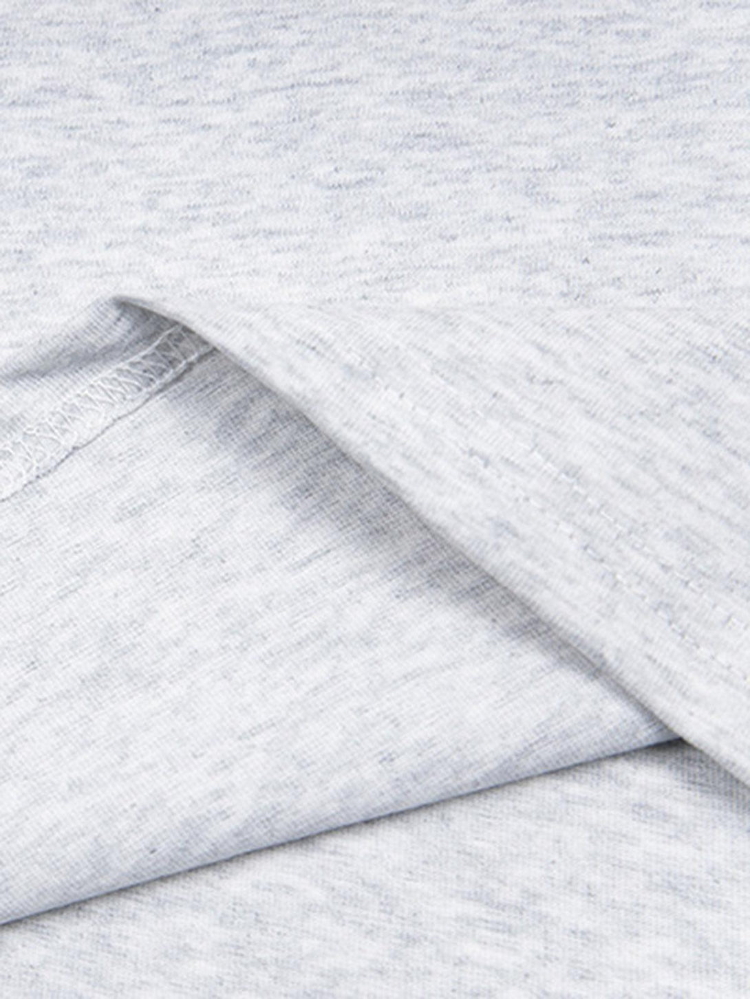 A tight crop highlighting TALISHKO's light gray T-shirt fabric and subtle texture.