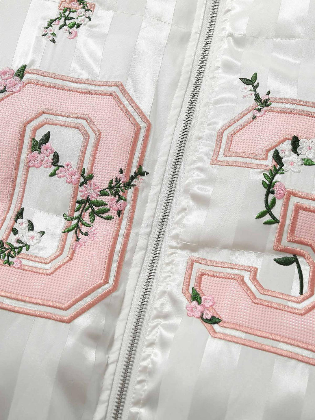 Intricate look at floral embroidery and lettering on the cotton coat by TALISHKO.