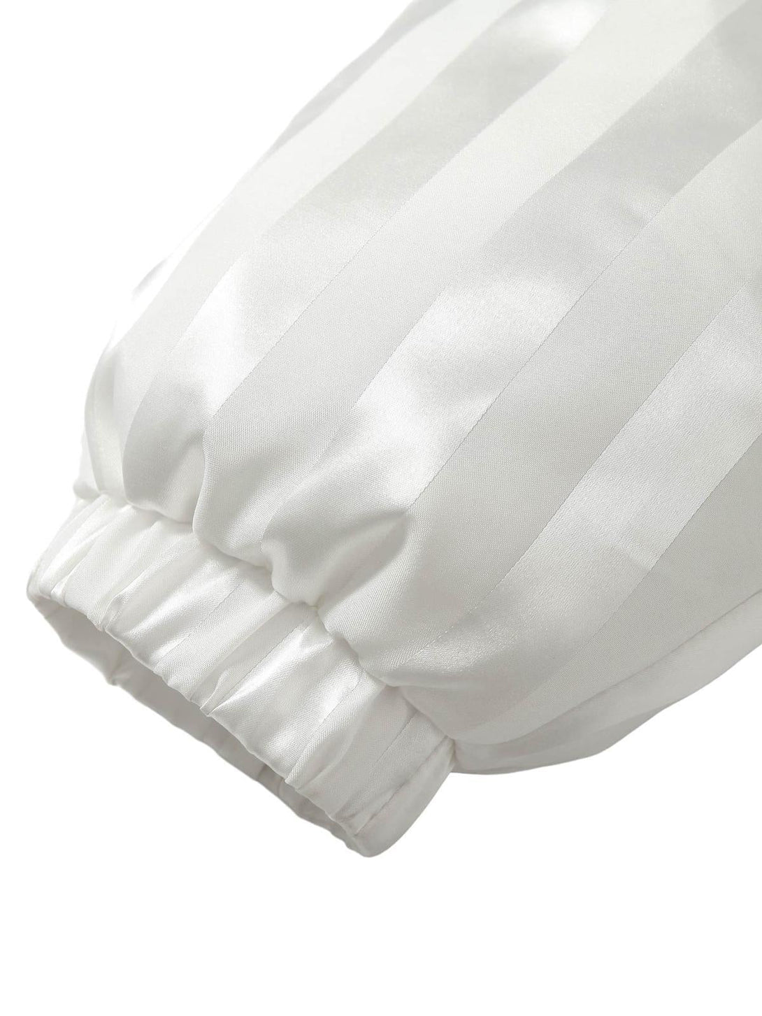 Focusing on the striped sleeve detail of a cotton coat by TALISHKO, showcasing texture and style.