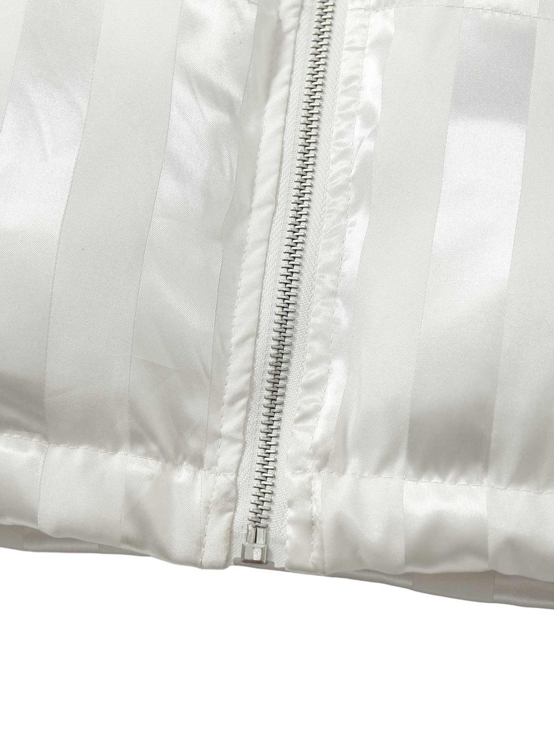"Detailed view of the zipper and fabric texture on a white cotton coat by TALISHKO."