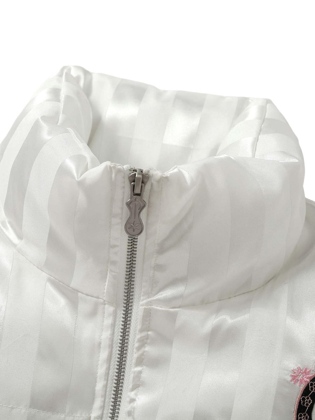 "Detailed view of the stand collar and zipper on a white cotton coat by TALISHKO."