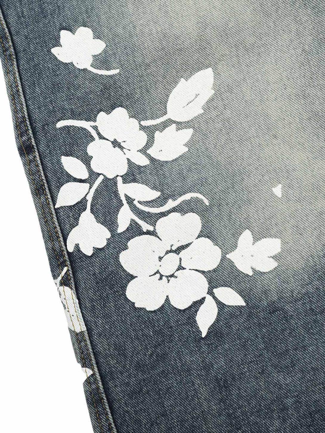 Detailed floral design on TALISHKO denim shorts, showcasing summer-ready style.