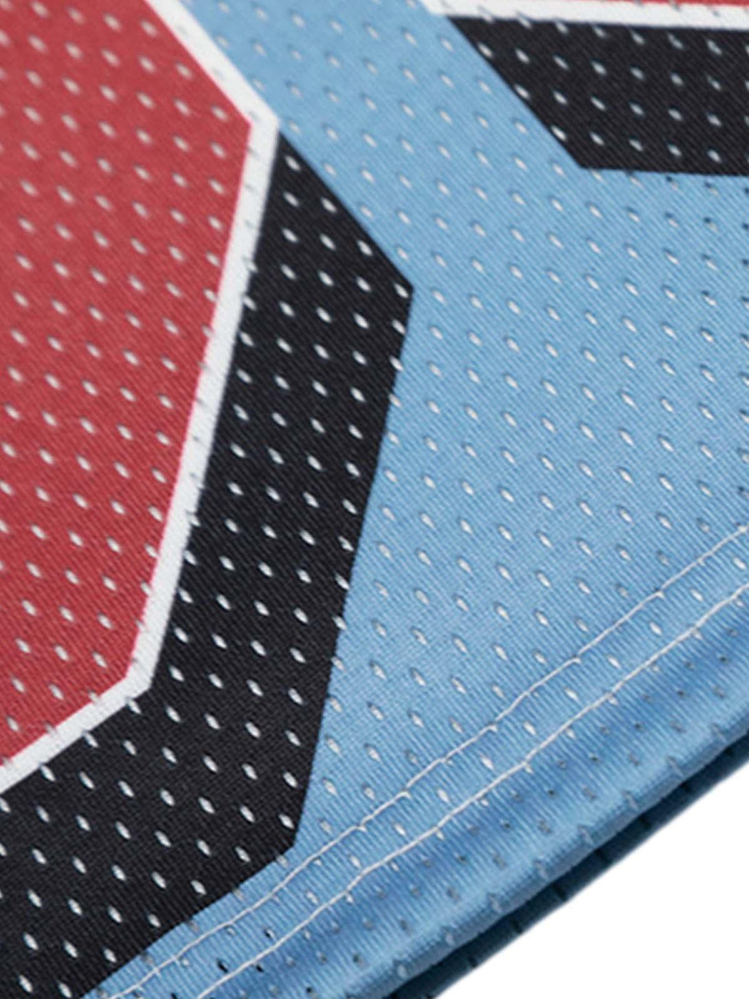 Zoomed-in texture of TALISHKO's floral print jersey, featuring intricate stitching and vibrant colors.