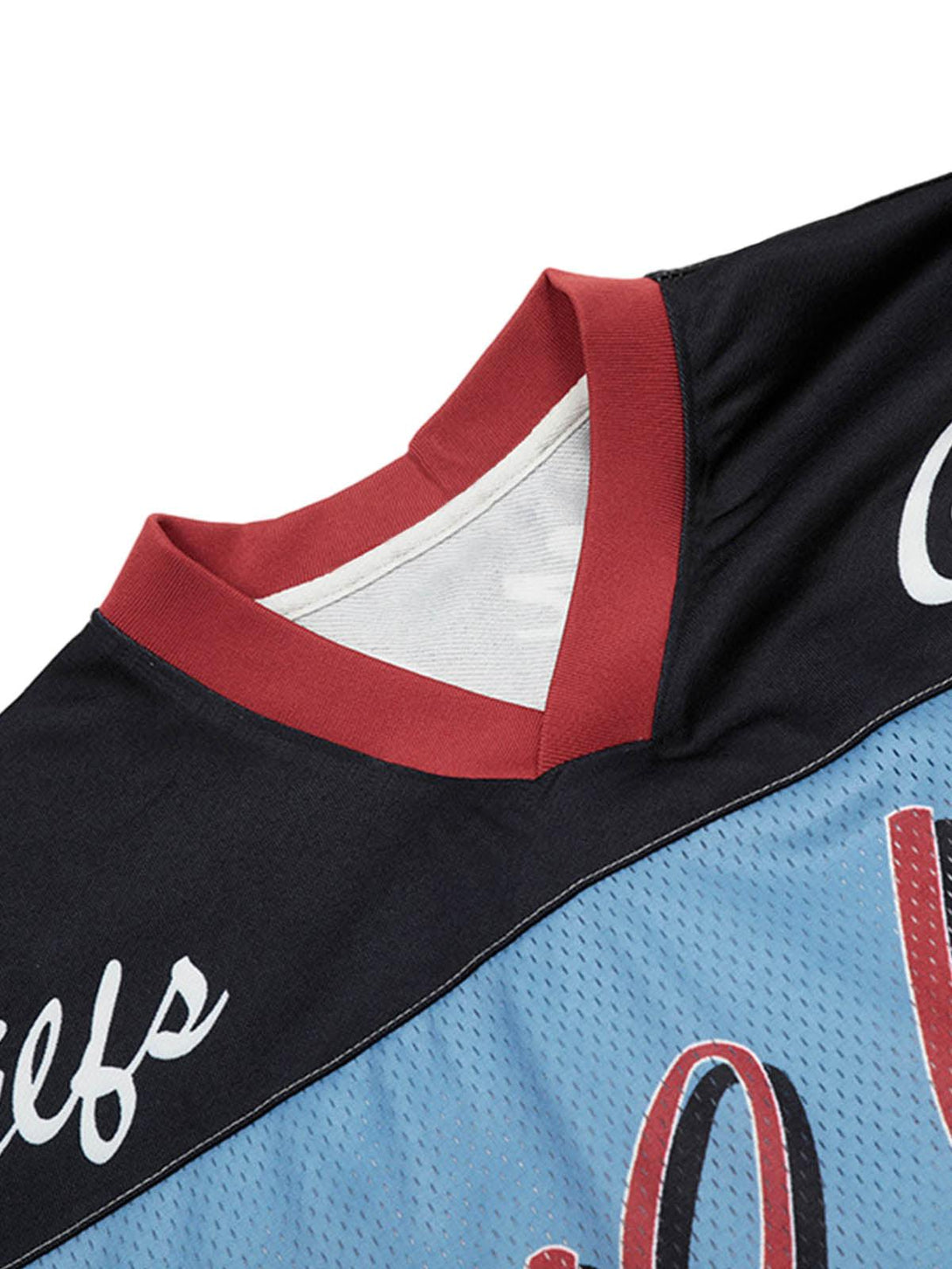 Focusing on the V-neck detail of TALISHKO's floral print jersey, highlighting its stylish contrast.