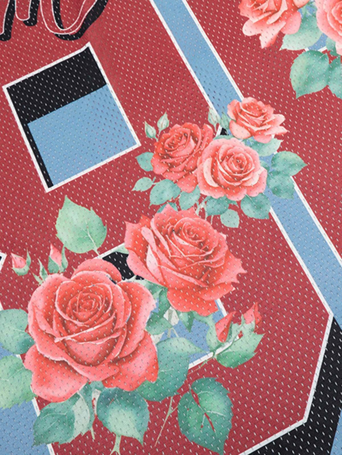 A tight crop highlighting TALISHKO's floral jersey design with vibrant rose patterns and texture.
