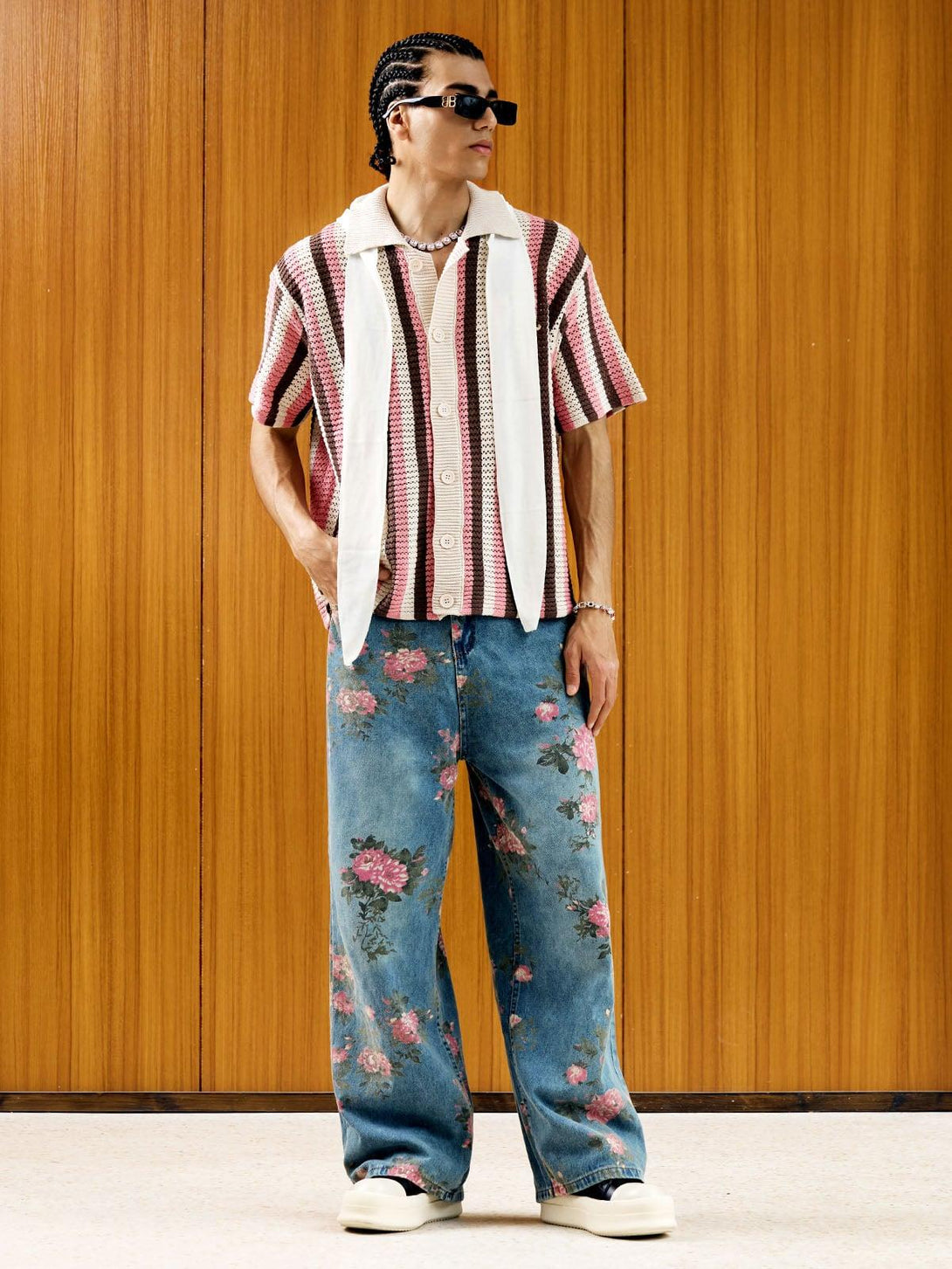 Model wearing floral print jeans by TALISHKO with a striped shirt, capturing a stylish vibe.