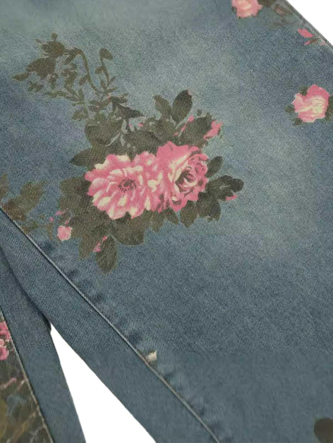 Intricate look at TALISHKO floral print jeans, showcasing pink roses on a denim background.