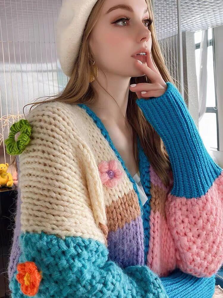 TALISHKO cardigan with vibrant floral details and oversized sleeves, worn stylishly with a beret.