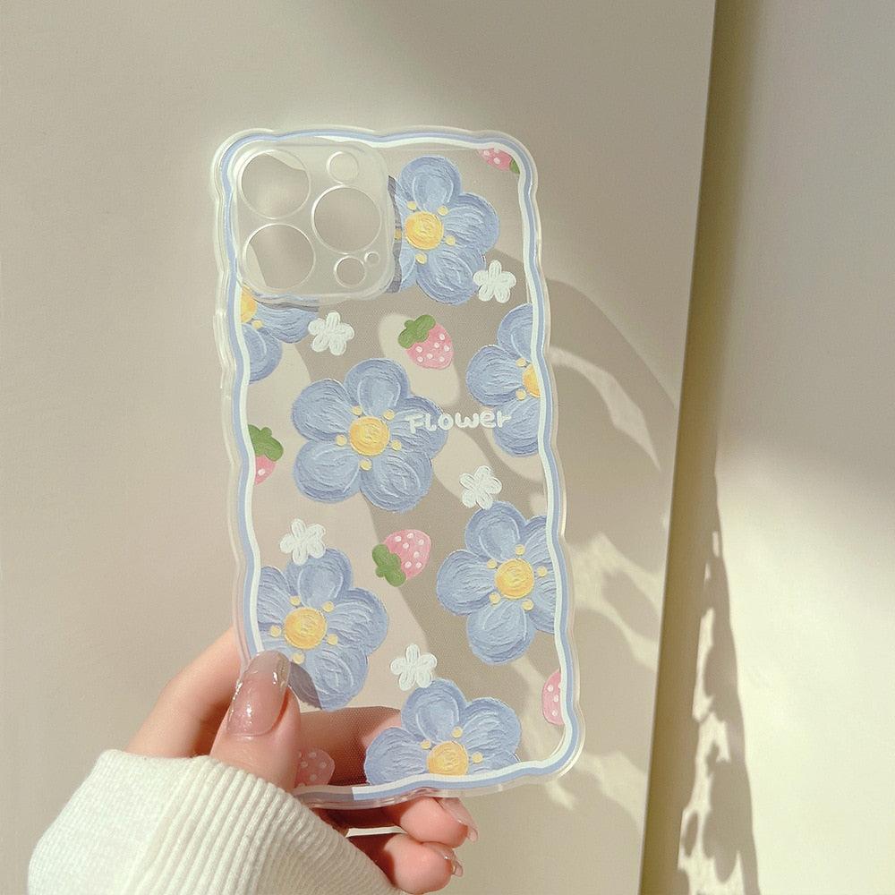 A close-up of TALISHKO iPhone case featuring blue flowers and strawberries with a wavy edge.