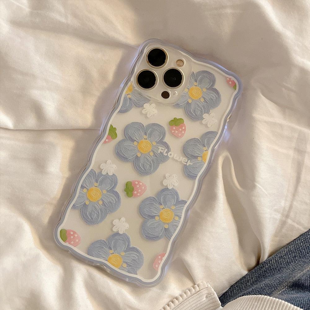 TALISHKO iPhone case showcases blue flowers and strawberries on a wavy-edged design.