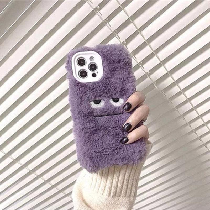A playful purple fluffy phone case by TALISHKO, featuring a quirky monster face design.