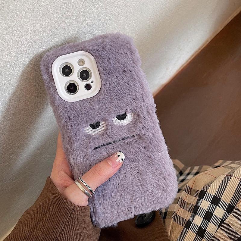 TALISHKO's fluffy monster phone case for iPhone showcases a quirky face design in a cozy texture.