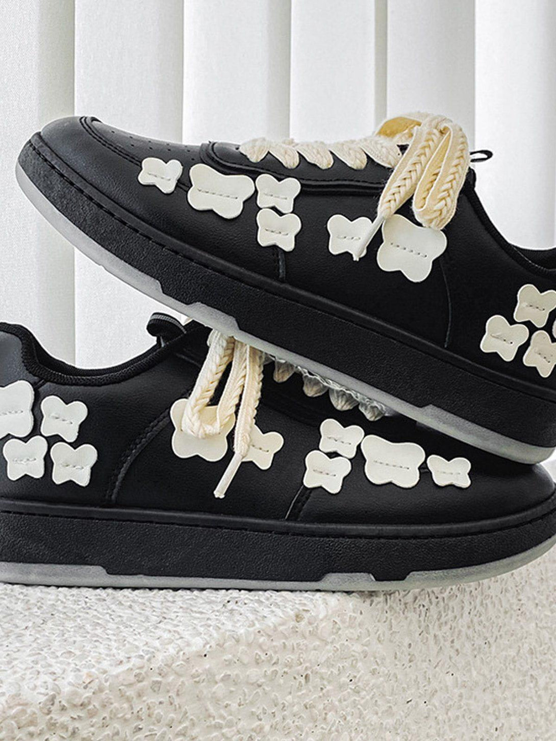 TALISHKO skate shoes with white butterfly accents, highlighting unique streetwear flair.