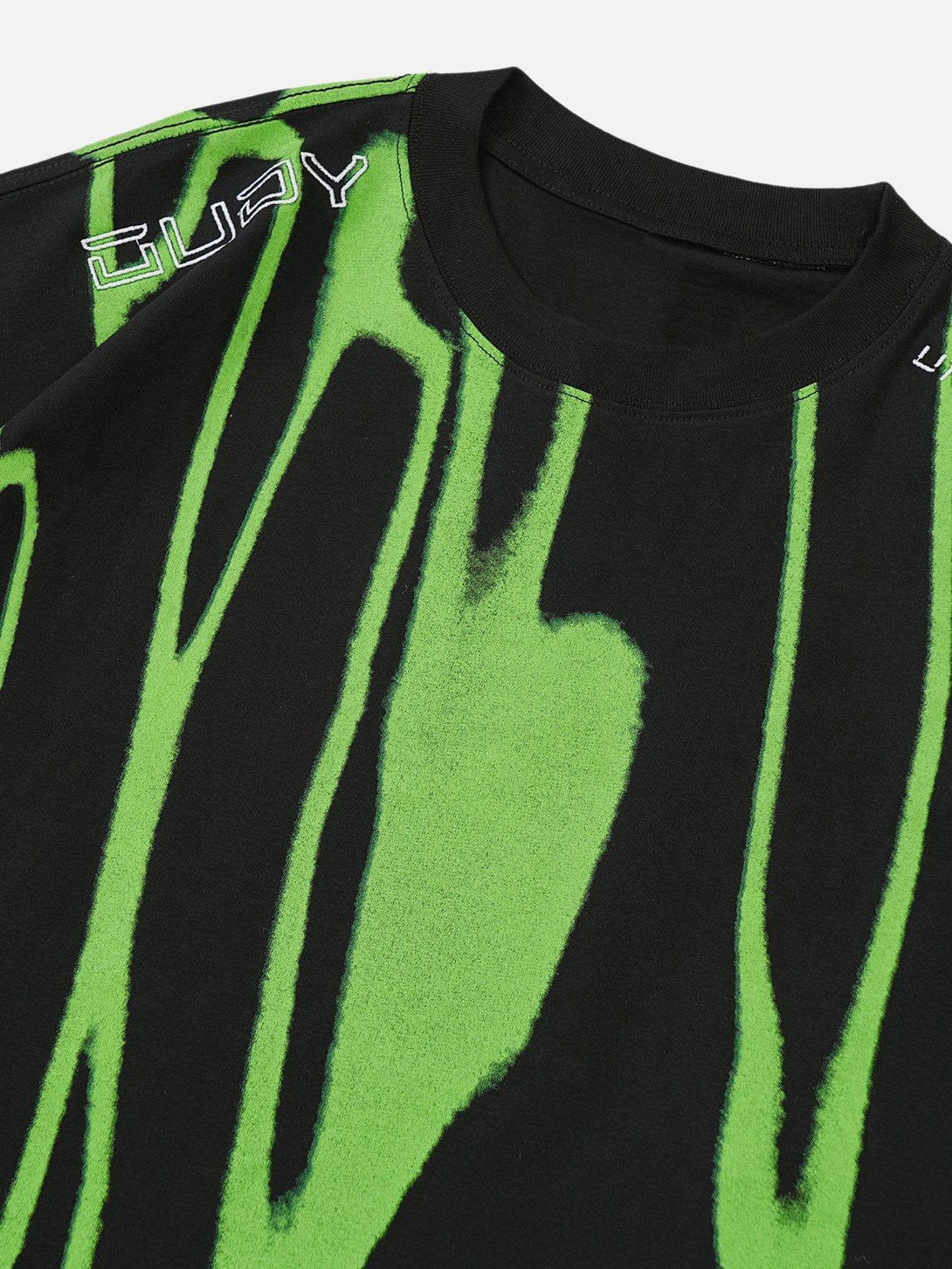 A close-up of a black tee with green abstract patterns by TALISHKO, highlighting bold design.