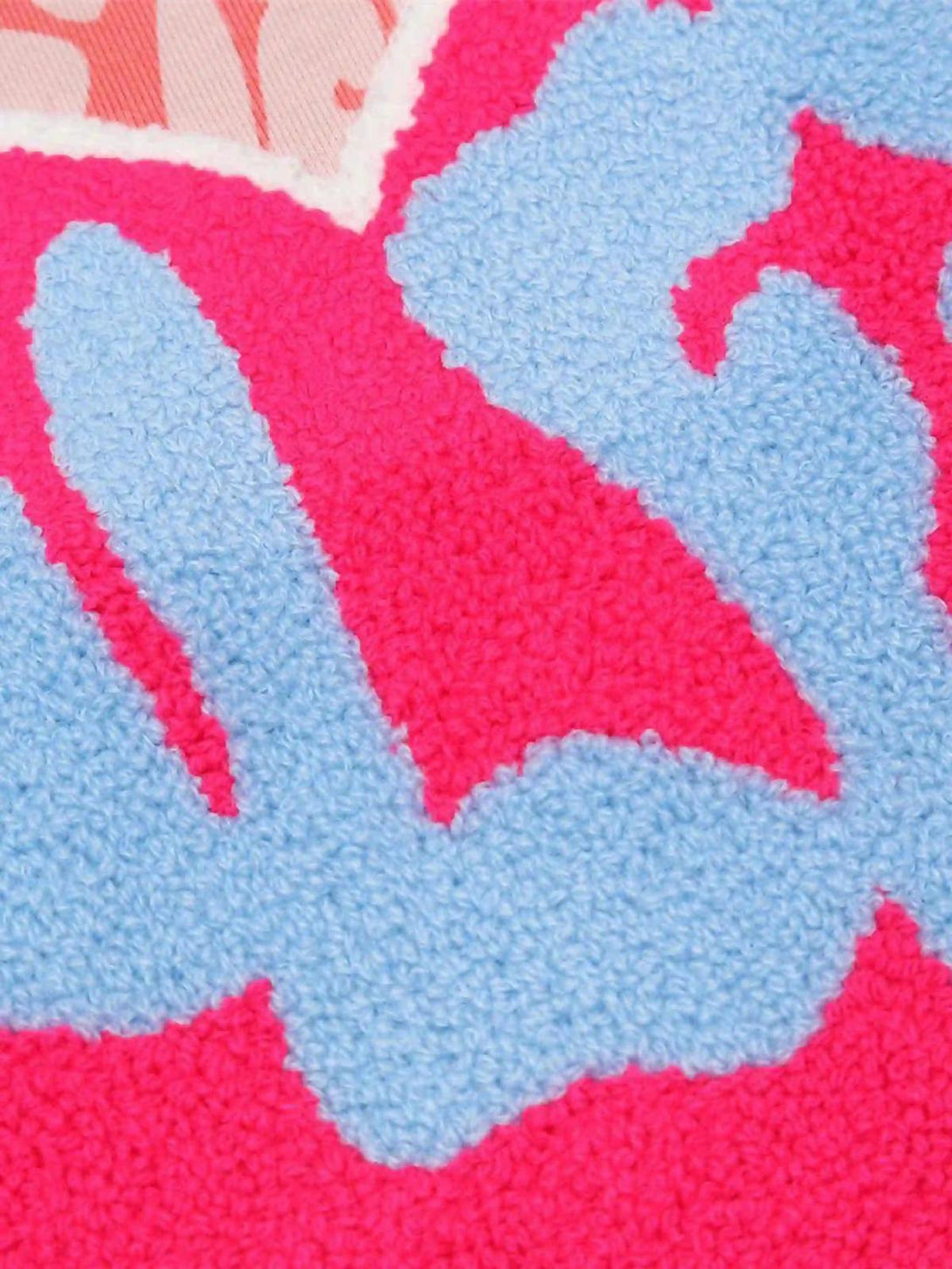 Intricate look at the vibrant graphic texture on a pink Foam Heart Hoodie by TALISHKO.