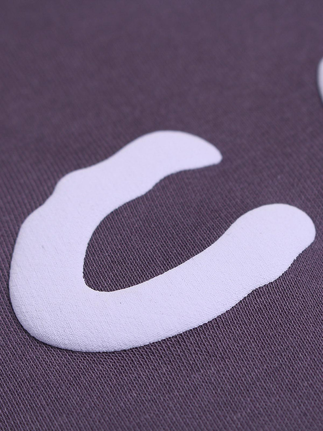 Zoomed-in view of a foam letter design on a TALISHKO hoodie, highlighting texture detail.