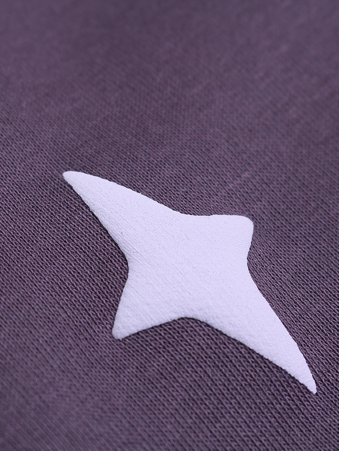 A close-up detail of a white star design on a TALISHKO hoodie, highlighting texture and color.