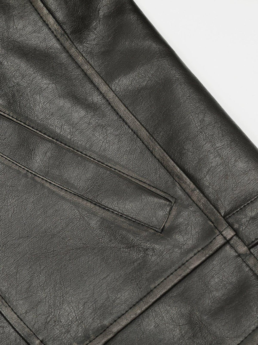 Zoomed-in view of TALISHKO's washed faux leather jacket, highlighting its textured detail.
