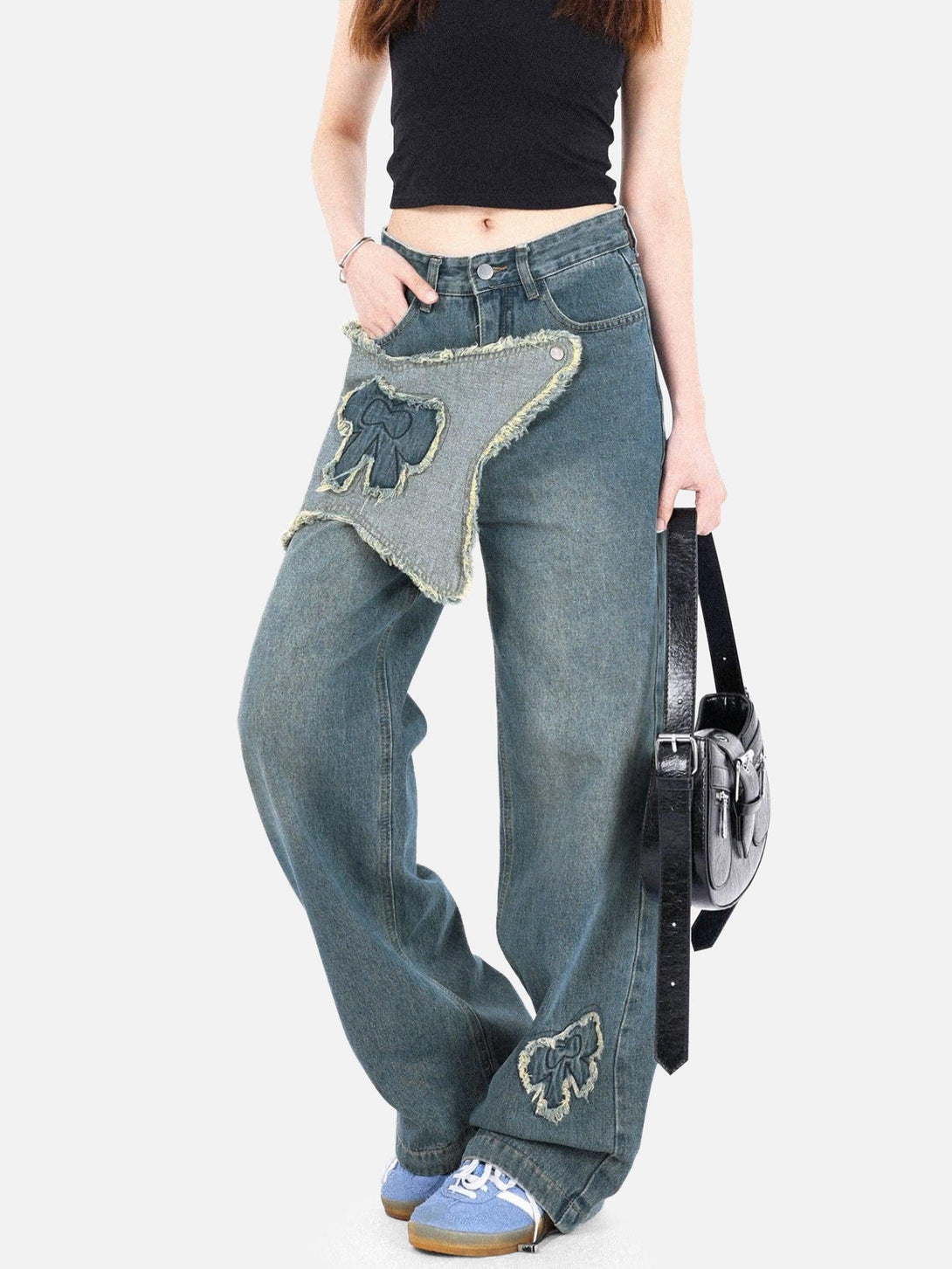 Model in TALISHKO fringe bow jeans with edgy patchwork and a casual, stylish fit.