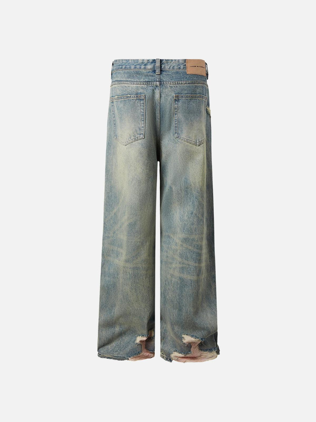 Back view of TALISHKO fringe distressed jeans showing unique wear-and-tear details.