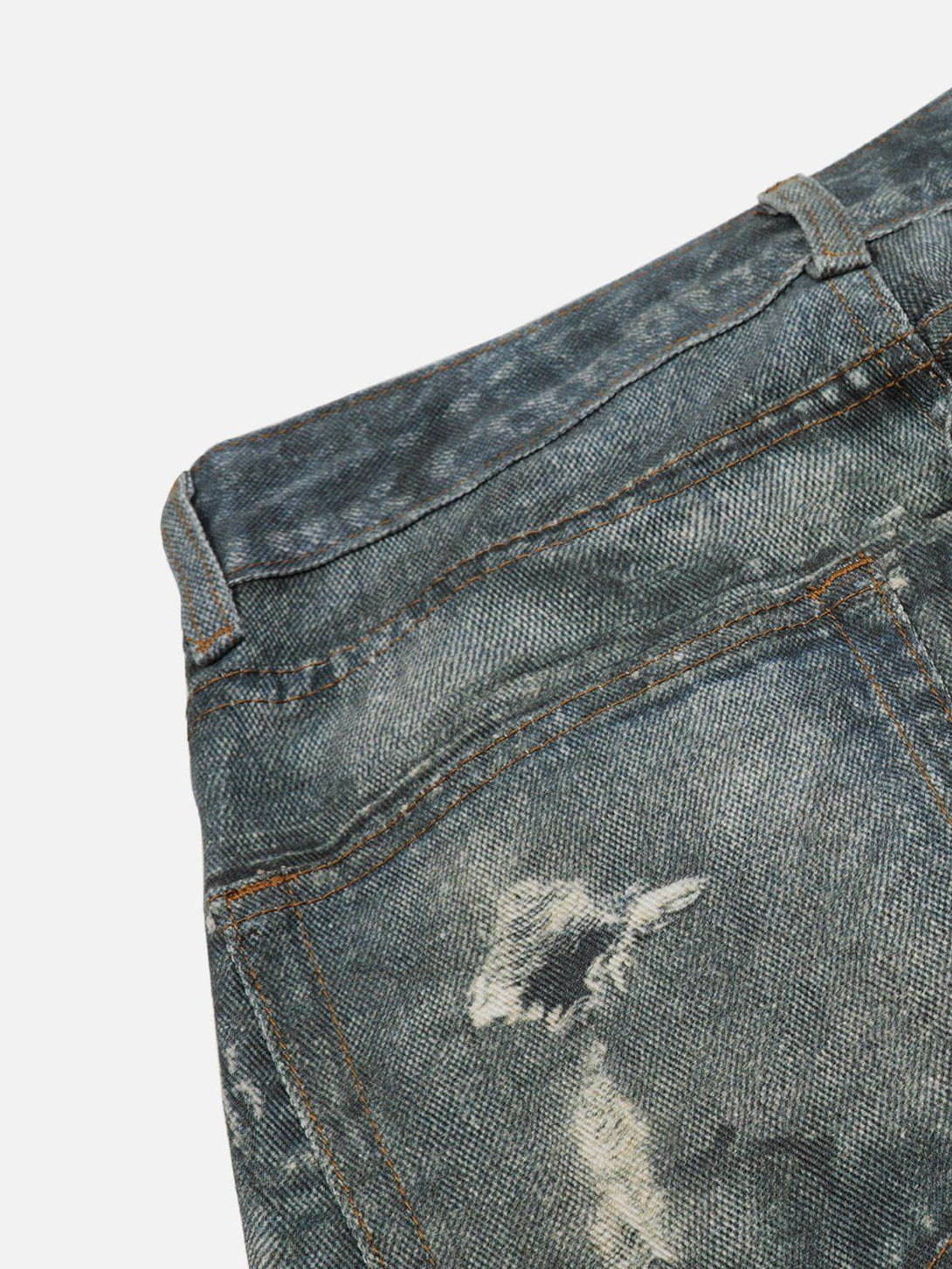 Detailed view of TALISHKO's distressed print jeans, highlighting the unique fabric texture.