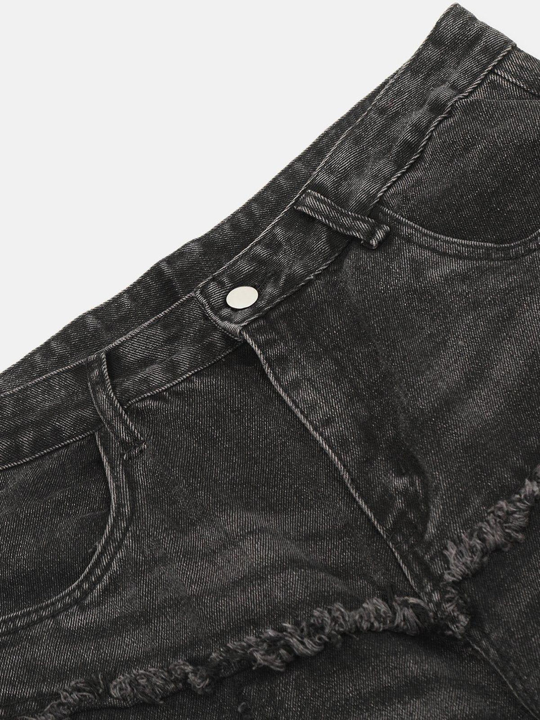 Detailed fabric and stitching of TALISHKO's black fringe multi-pocket jeans, highlighting texture.
