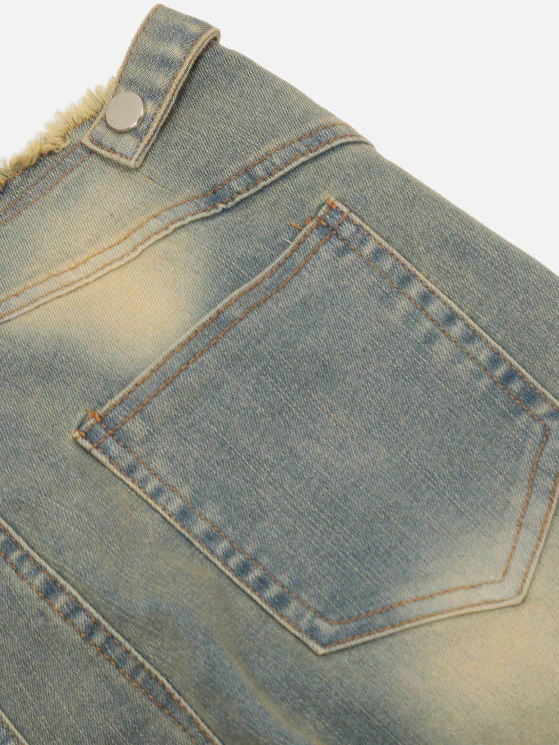 Detailed fabric and stitching of TALISHKO's fringe waist jeans, highlighting their unique style.