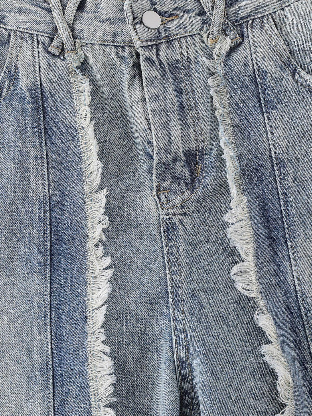 Detailed view of TALISHKO's fringe washed jeans, highlighting the frayed texture and stitching.