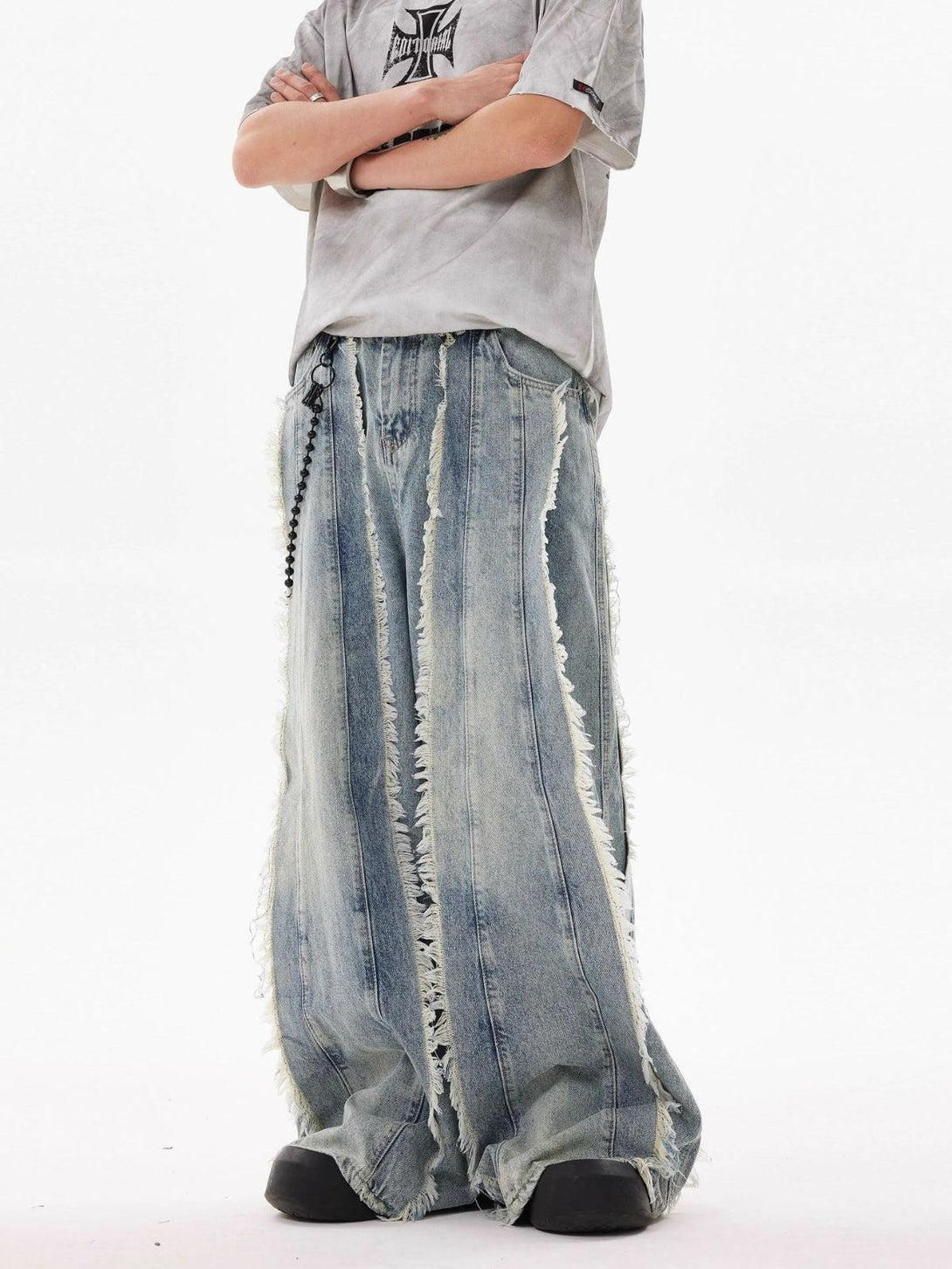Wide-leg fringe washed jeans by TALISHKO, styled with a relaxed tee in a casual look.