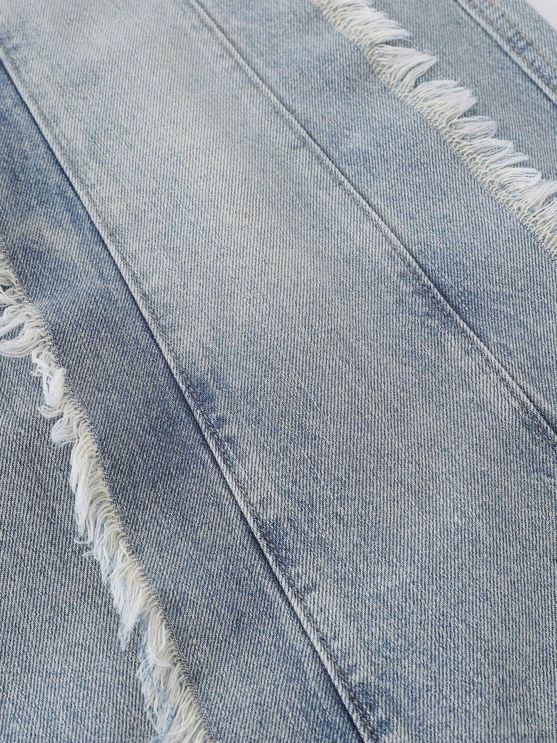 Intricate look at TALISHKO's fringe washed jeans, focusing on the frayed texture and stitching.