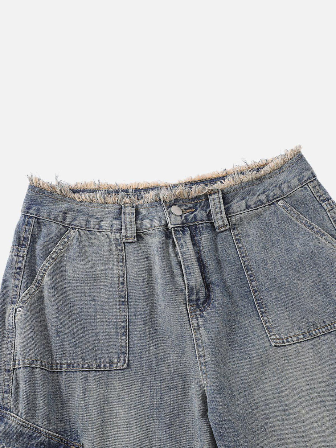 A detailed view of TALISHKO's fringe waist on washed multi-pocket jeans, highlighting denim texture.