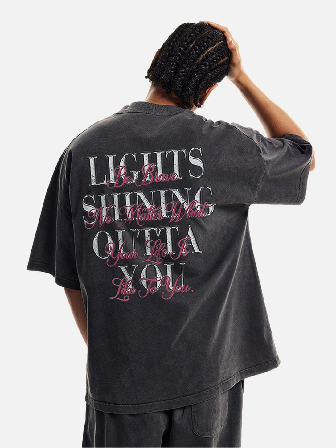 Model showcasing the back of a TALISHKO T-shirt with motivational text, adding a stylish touch.