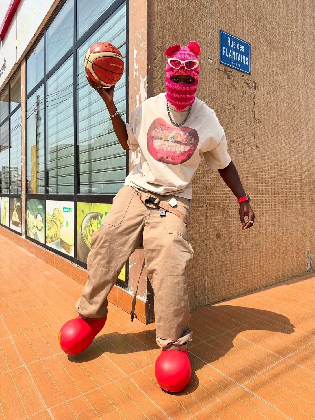 Streetwear by TALISHKO: model in graphic tee with bold accessories and basketball flair.