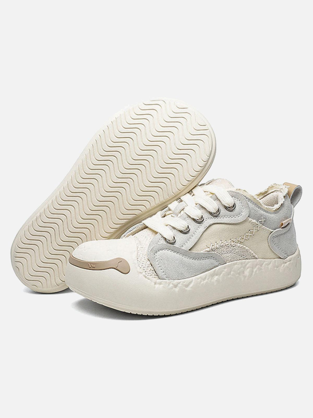 TALISHKO leather spliced sneakers in a playful design, showcasing textured soles and side details.