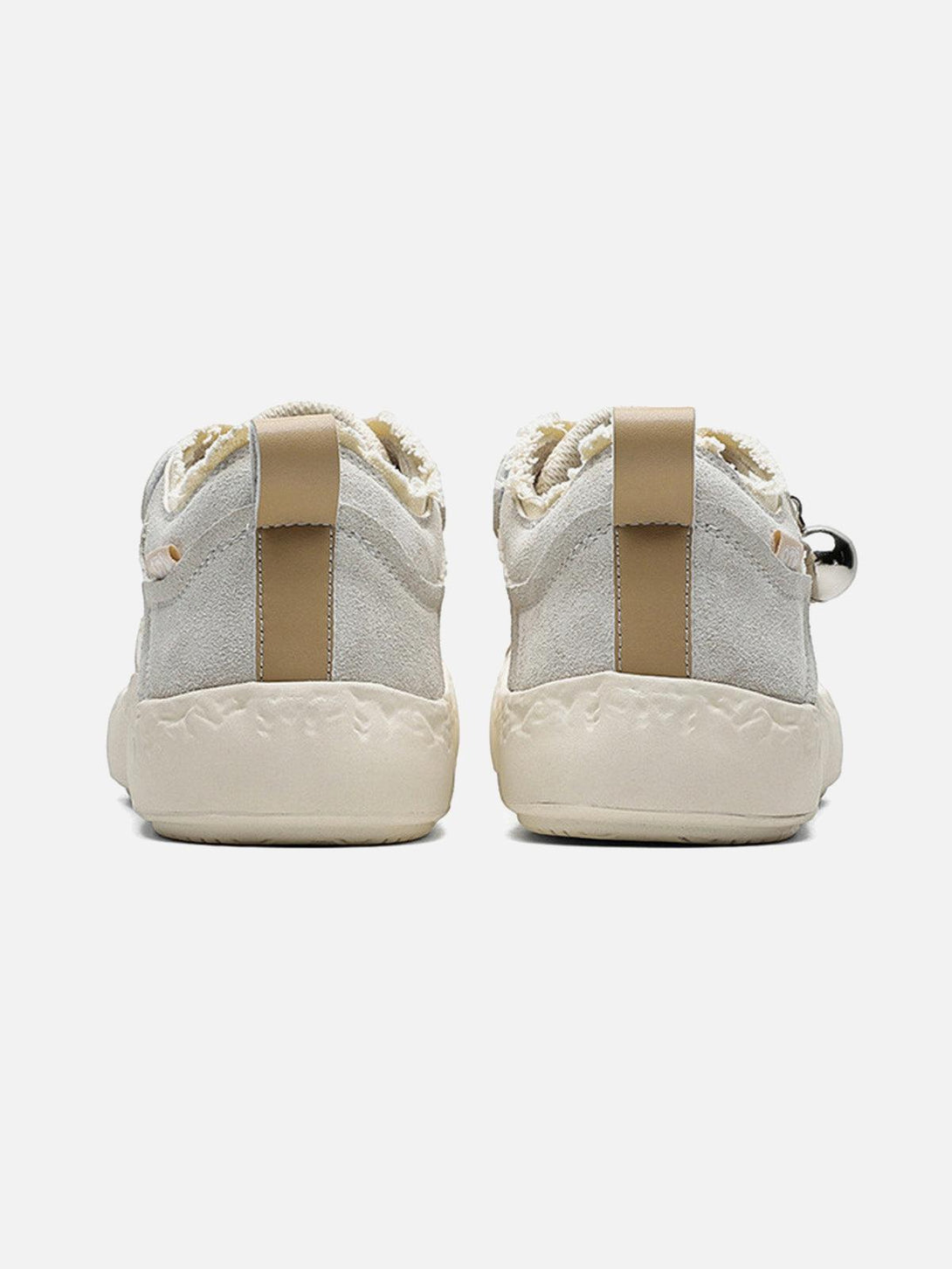 Rear view of TALISHKO sneakers with textured soles and beige pull tabs for a stylish touch.