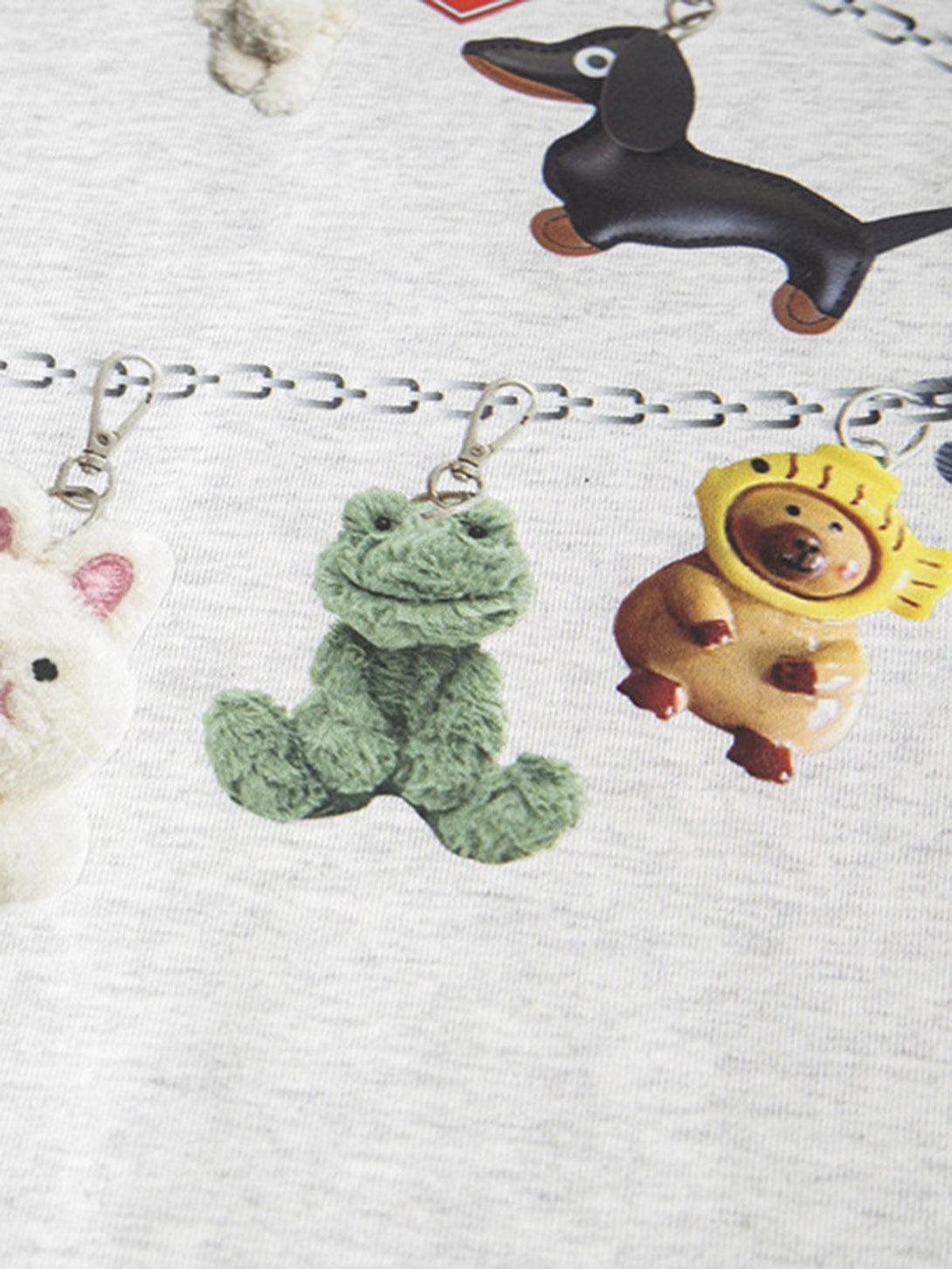 A detailed view of TALISHKO's cartoon print T-shirt, showcasing fun character keychain designs.