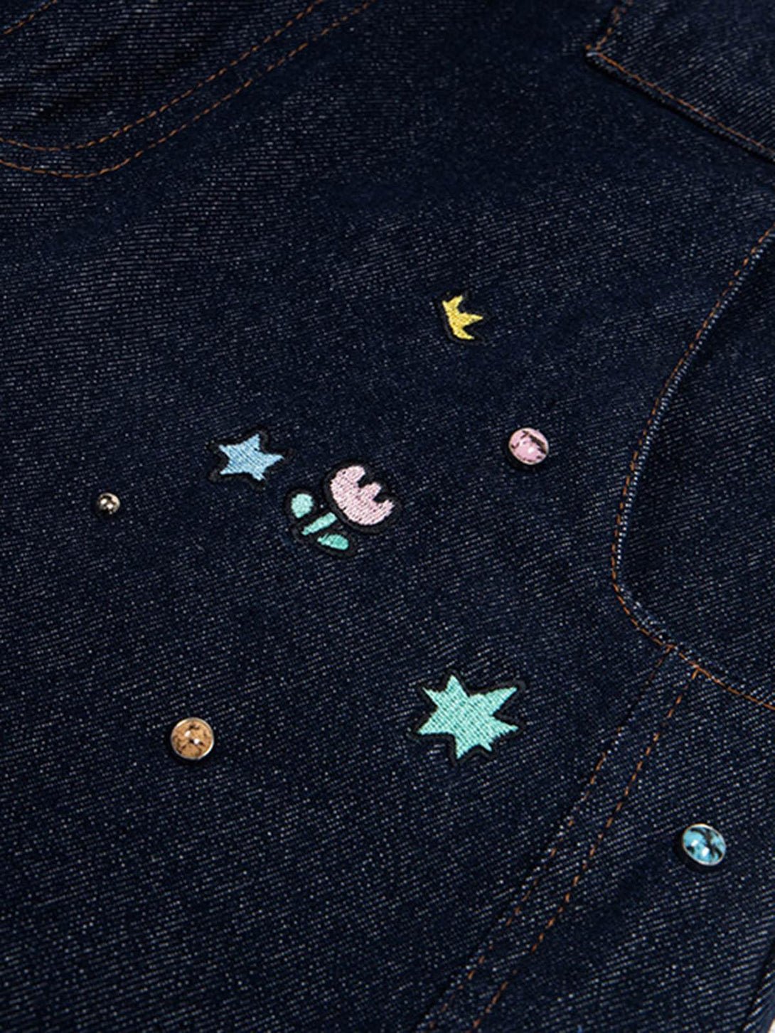 Intricate look at TALISHKO barrel jeans showcasing playful embroidery and decorative details.