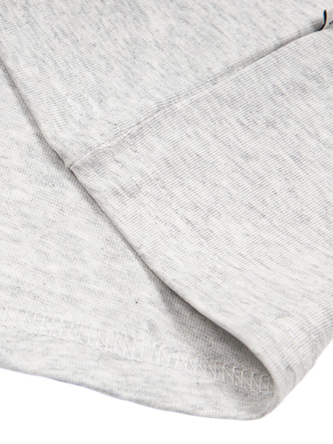 A detailed look at TALISHKO's gray T-shirt sleeve, highlighting the soft fabric texture.
