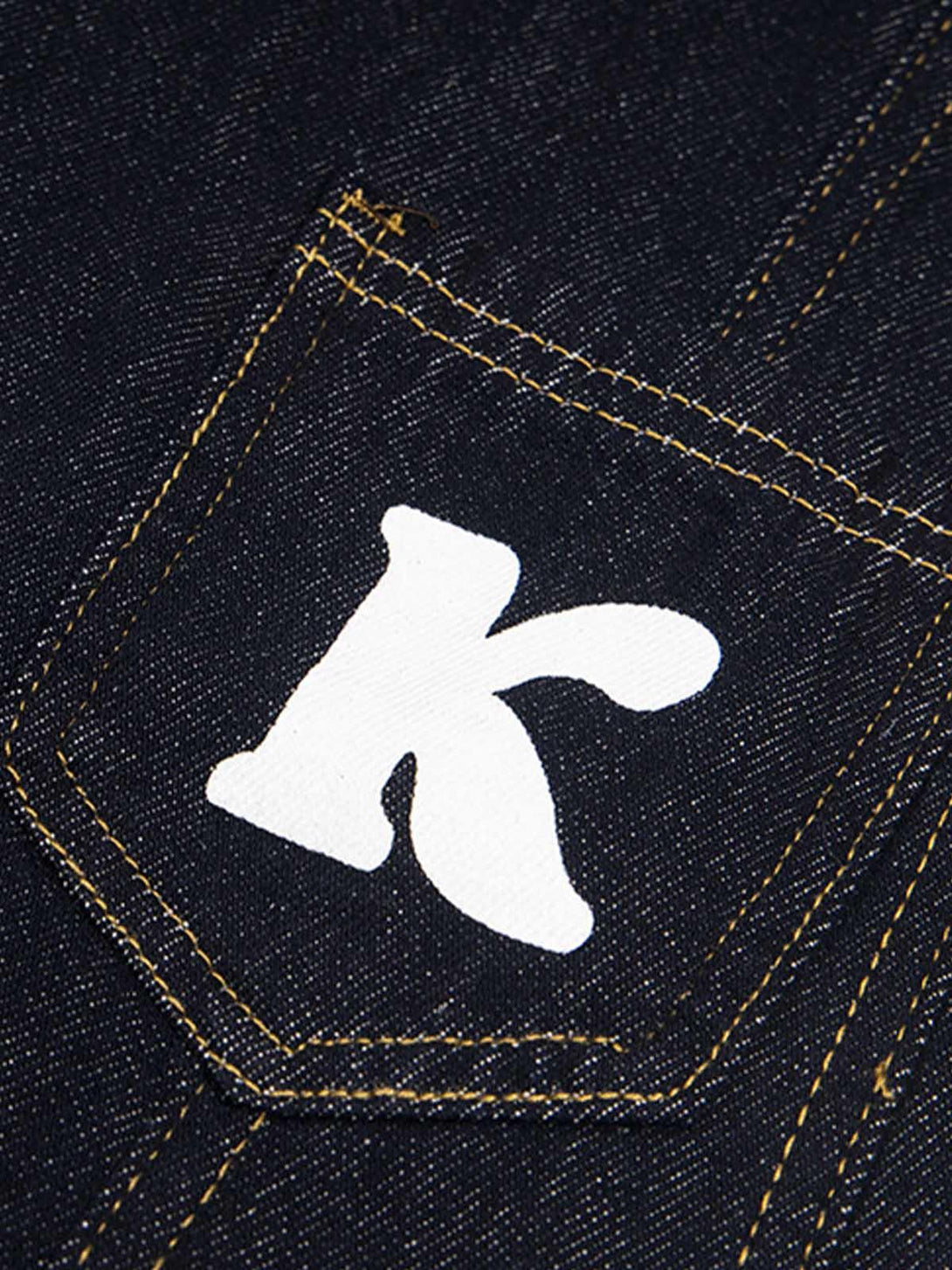 TALISHKO jeans with a playful letter "K" on the pocket, showcasing detailed stitching.