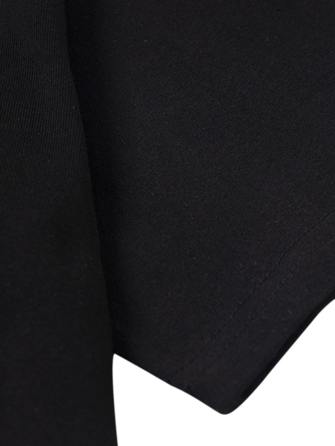 A tight crop highlighting the sleek black fabric of the TALISHKO "Love Me" T-shirt.