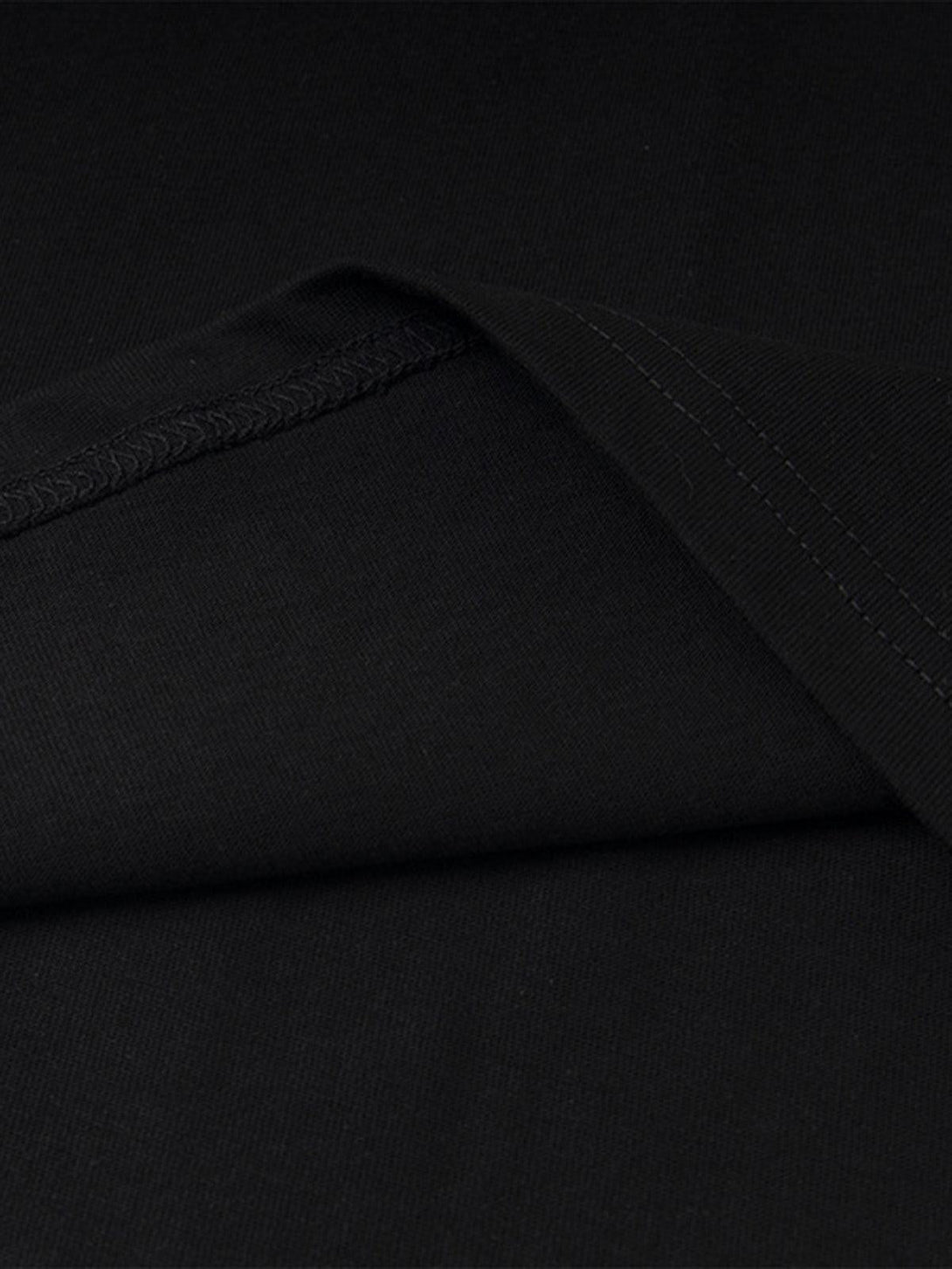 Detailed fabric and stitching of the TALISHKO "Love Me" T-shirt in sleek black.