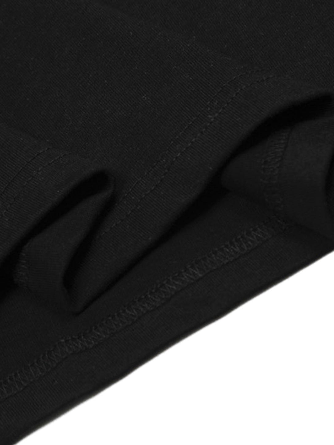 Intricate look at the stitching and fabric of a black T-shirt, showcasing TALISHKO's quality.