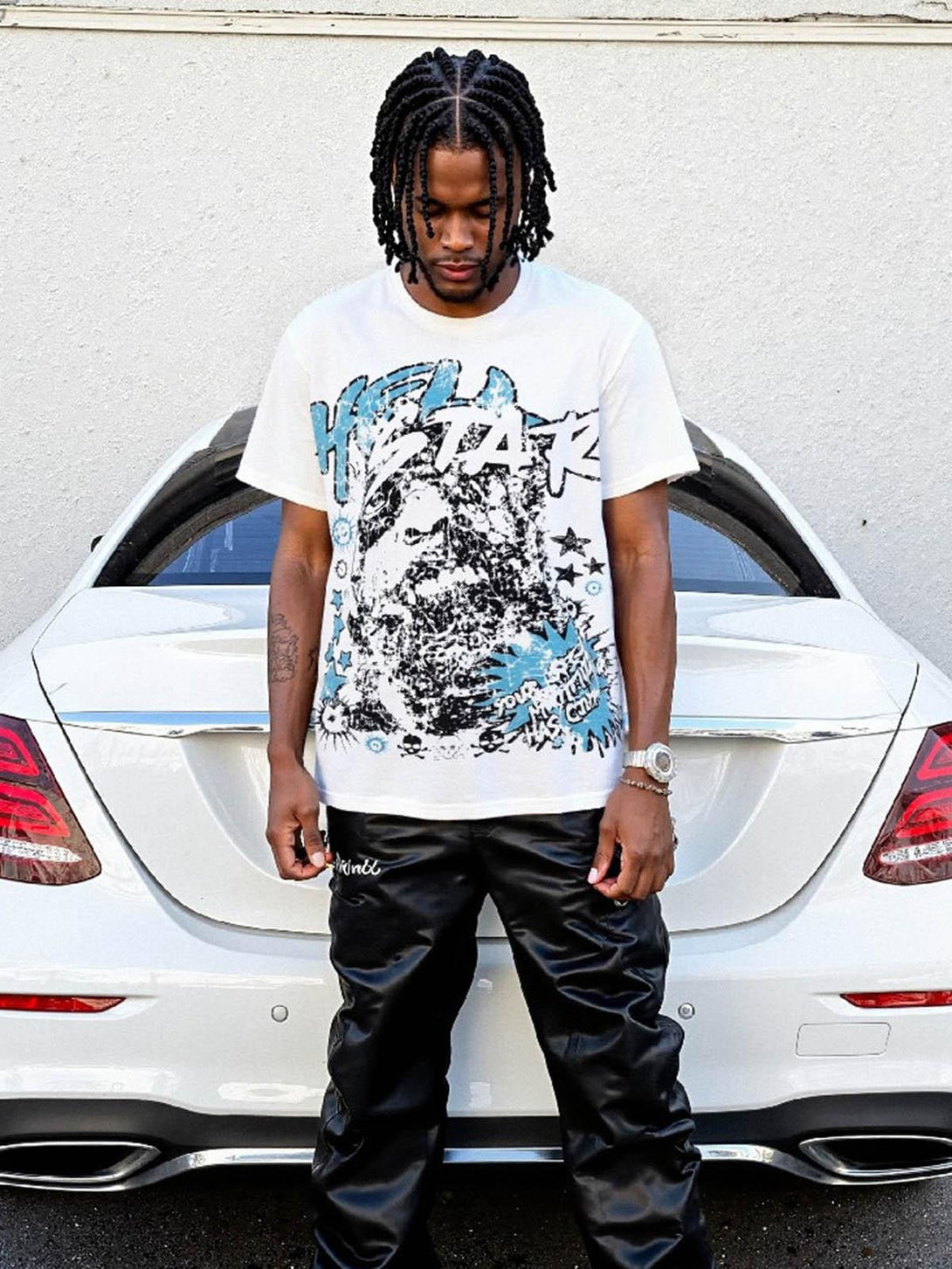 Model wearing a TALISHKO fun graphic T-shirt, styled effortlessly with black pants.