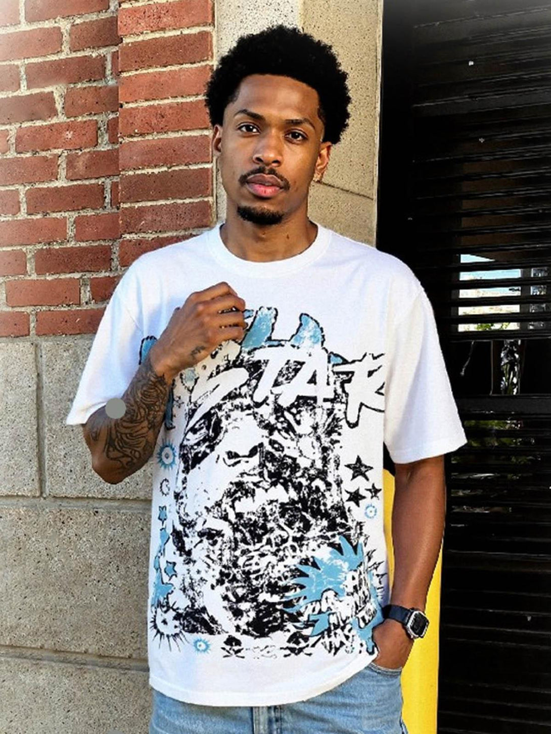 Model wearing a TALISHKO graphic T-shirt with vibrant artistic design, ideal for casual outings.
