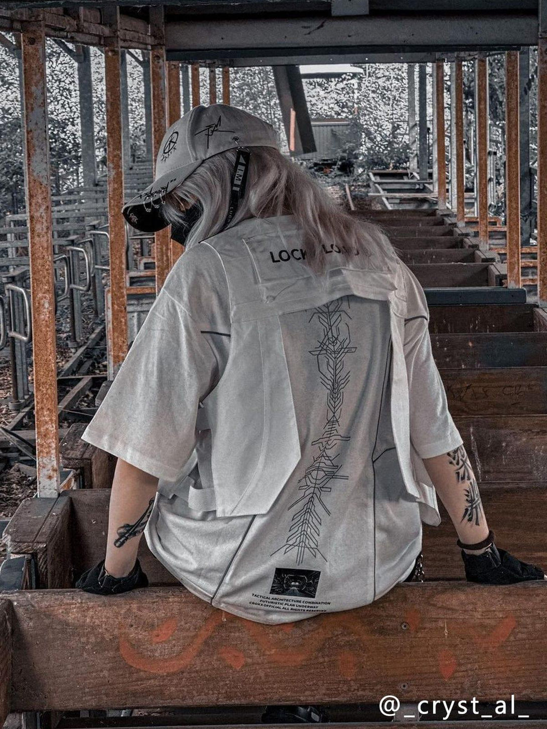 Back view of a white TALISHKO tee with reflective designs, perfect for an urban style.