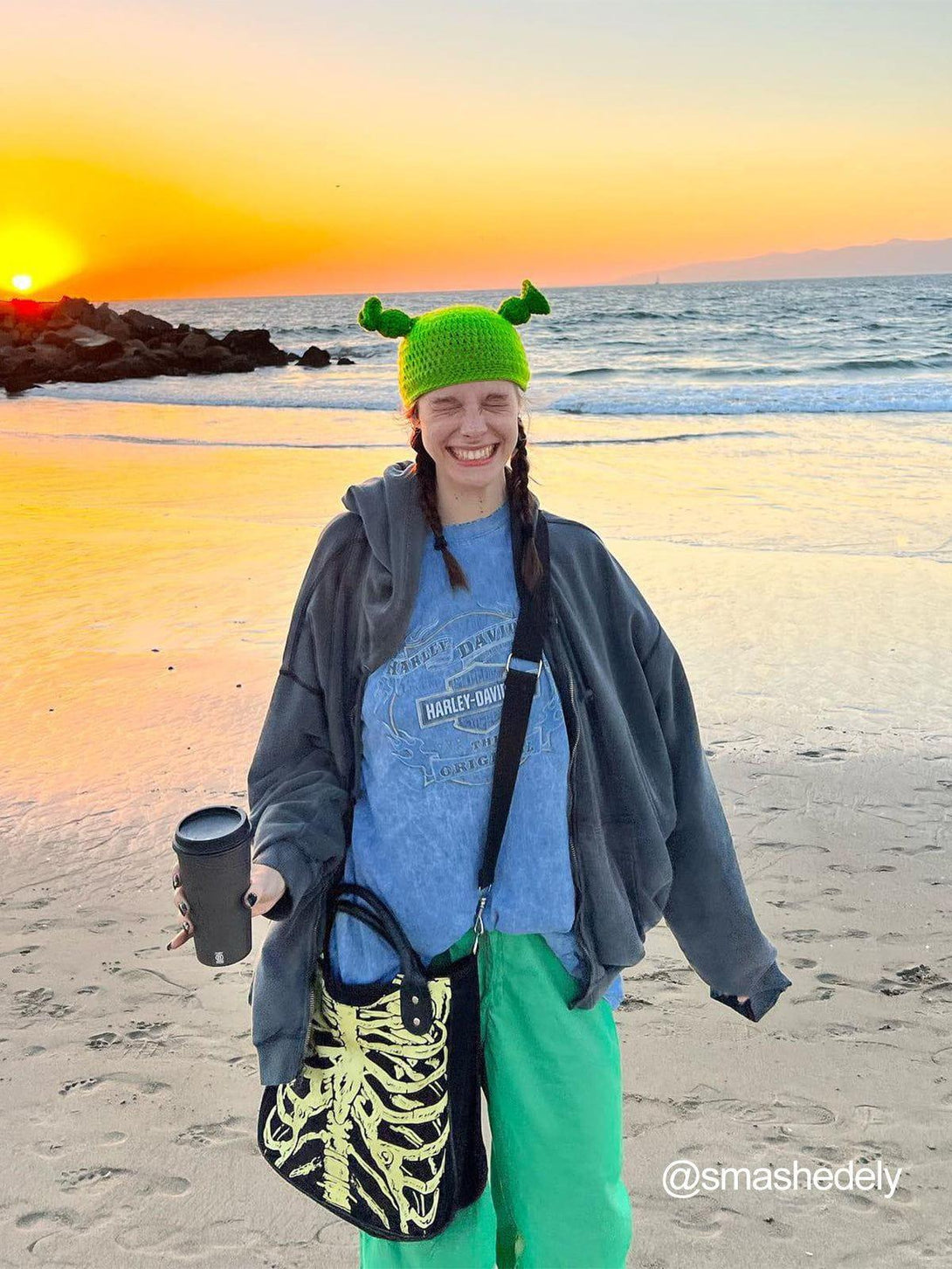 A cheerful beach scene featuring a playful green Shrek beanie by TALISHKO, adding a fun vibe.