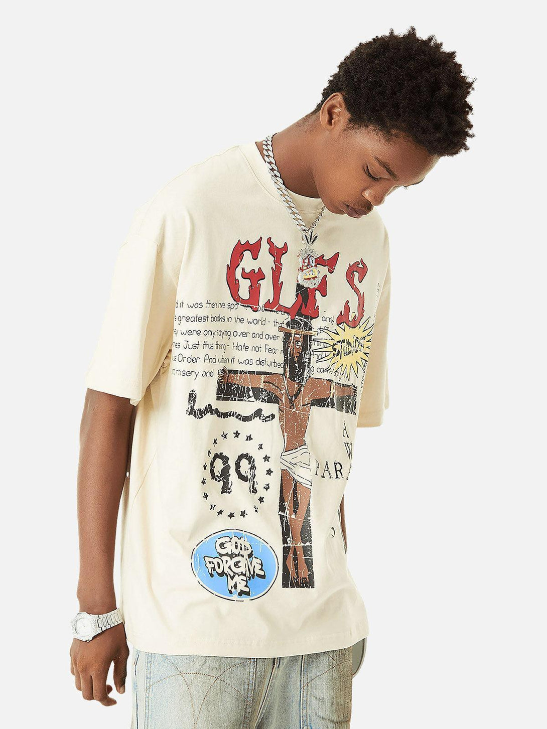 Model showcasing a TALISHKO graphic T-shirt with bold graffiti design, styled casually.