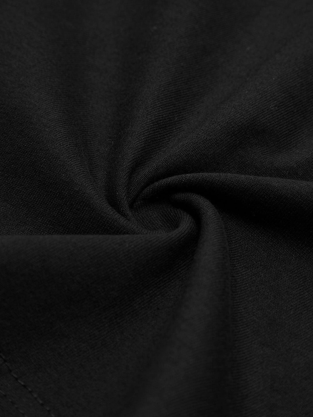 Intricate look at the black fabric texture of the TALISHKO graffiti T-shirt.