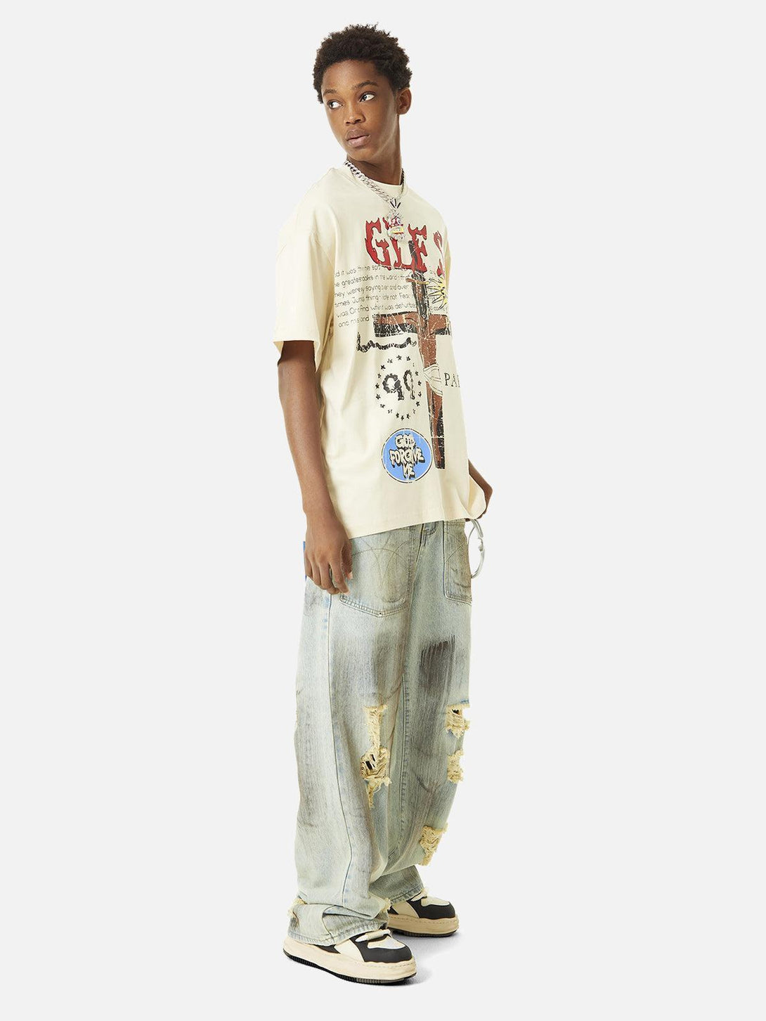 Model in TALISHKO graffiti T-shirt and distressed jeans, embodying a casual street style.