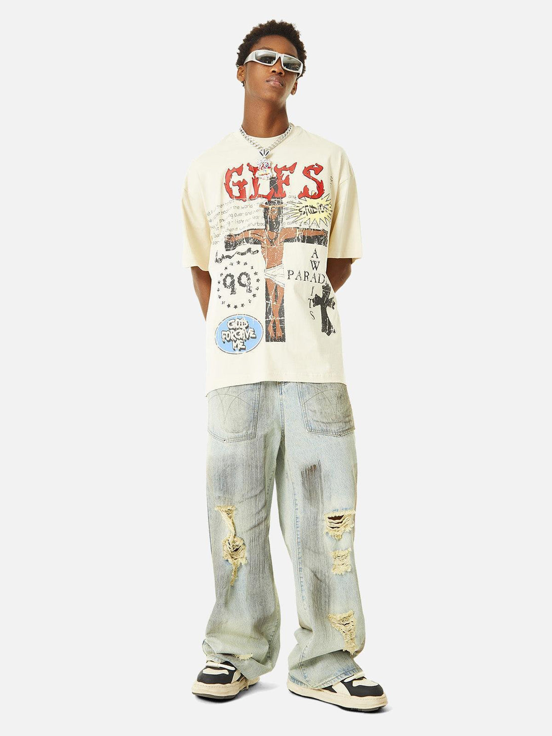 Model wearing a TALISHKO graffiti T-shirt with distressed jeans, highlighting streetwear style.